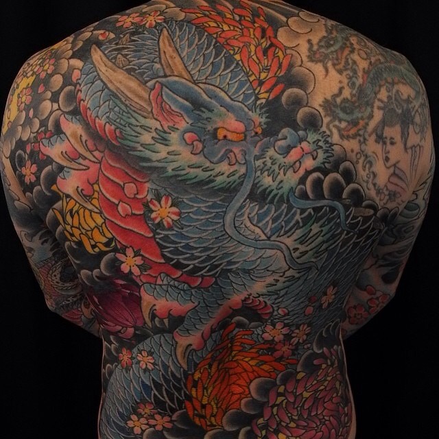 a back of a person with tattoos